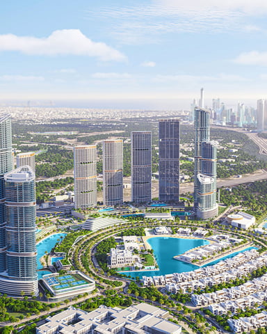 Aerial view of modern high-rise residential towers with turquoise pools, landscaped grounds, and Dubai skyline in distance