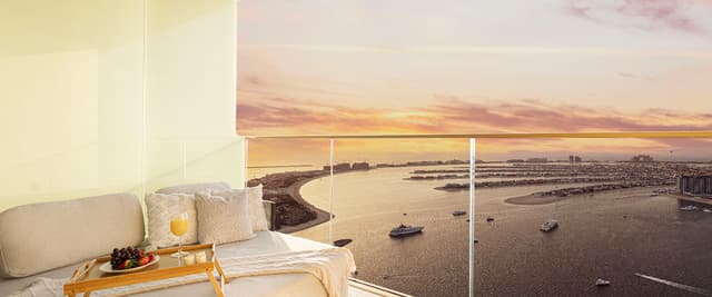 Bedroom with bed, wooden tray of fruit and juice, overlooking waterfront at sunset with boats and distant cityscape